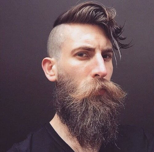 skin fade, thick beard and long and messy top hipster haircut