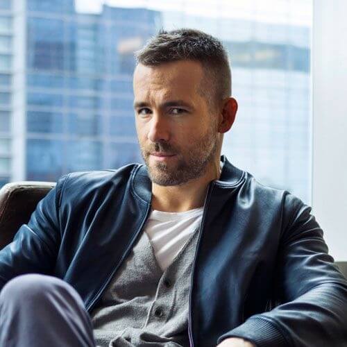 ryan reynolds sitting with a high and tight Receding Hairline cut