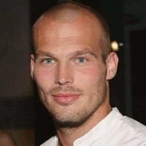 Side view of a man with a classic induction military haircut, highlighting the sharp taper and clean neckline