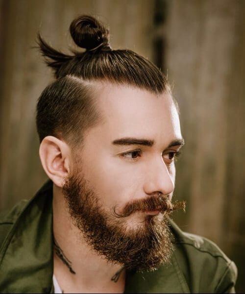 A photograph of an Asian male model with a top knot undercut hairstyle and  a denim shirt - Man Bun Hairstyle