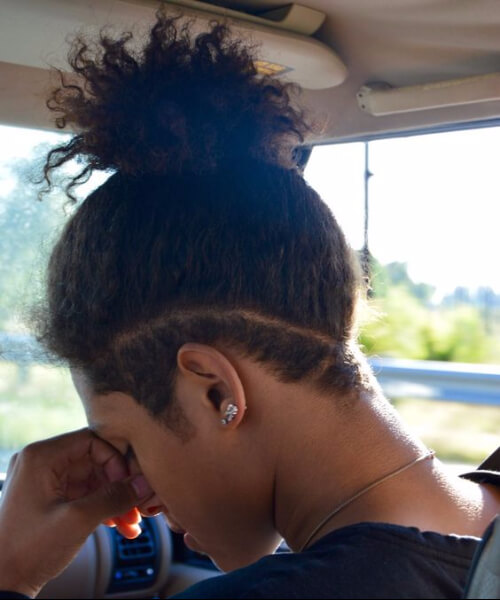 top knot undercut with curly hair