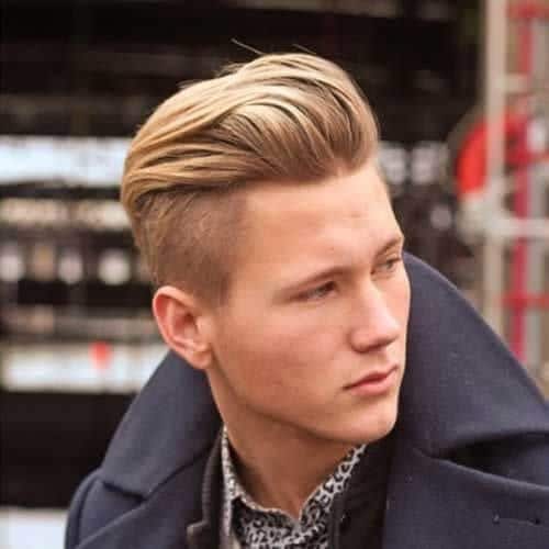 A man outdoor with his blonde layered haircuts