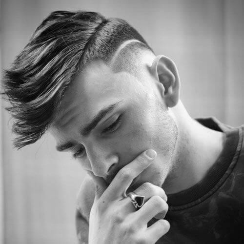 A man touching his face with his hair designs hairstyle