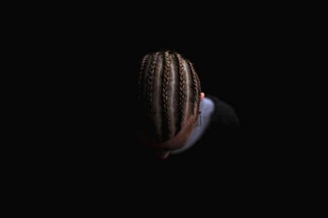 a man showing his head with braided hairstyles