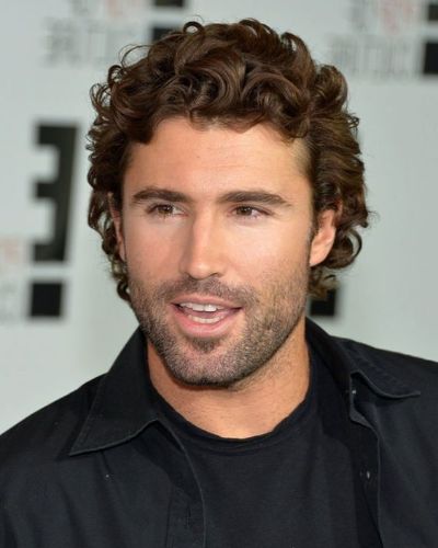 a man with Short to Medium Curls with trimmed beard