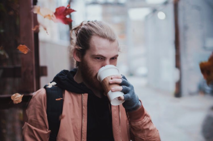 man drinking coffee autumn leaf falling featured image fall hairstyles