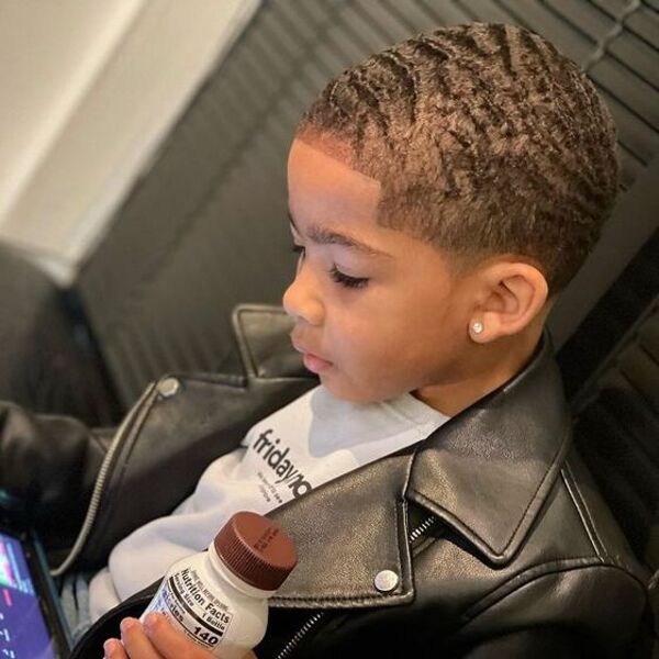 Afro Toddler Boy Haircuts with Blonde Hair - A boy had his Afro with Blonde watching video on his tablet