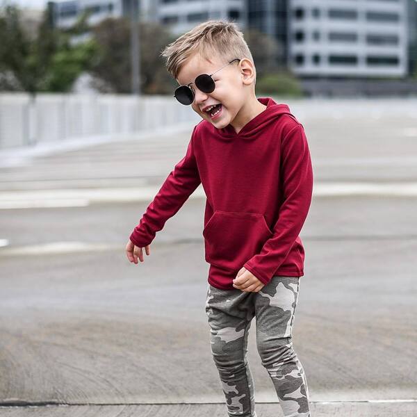Blonde Faux Hawk with Low Fade Toddler Boy Haircuts -A boy wearing dark maroon sweater