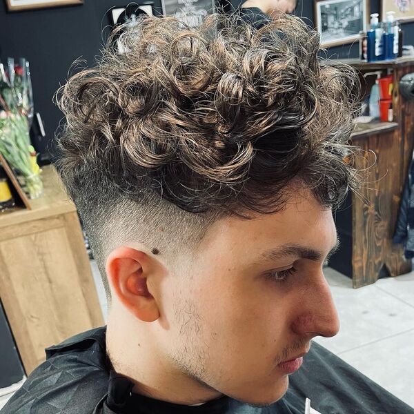 Curly Fade Haircut - a man had his Curly Fade Haircut with cape