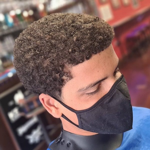 Curly Top Afro Hairstyle - a man had his Curly Top Afro Hairstyle with mask