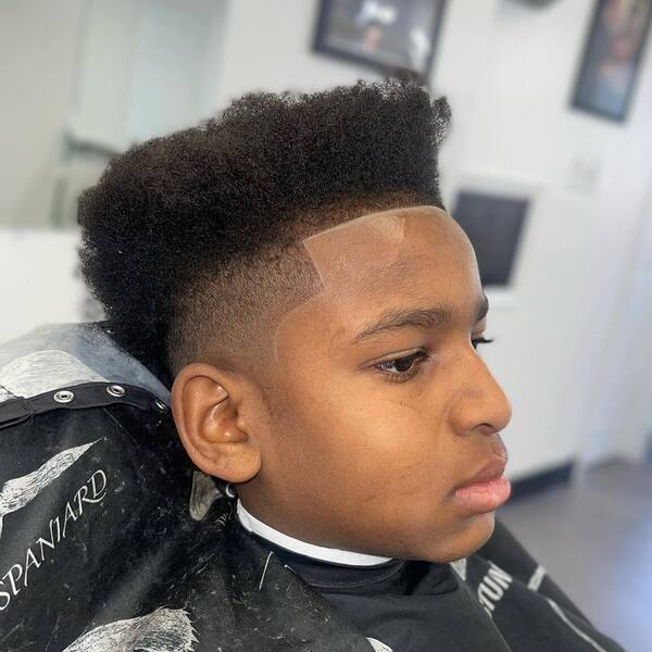 High Taper Fade Afro - a boy had his High Taper Fade Afro with hisrt