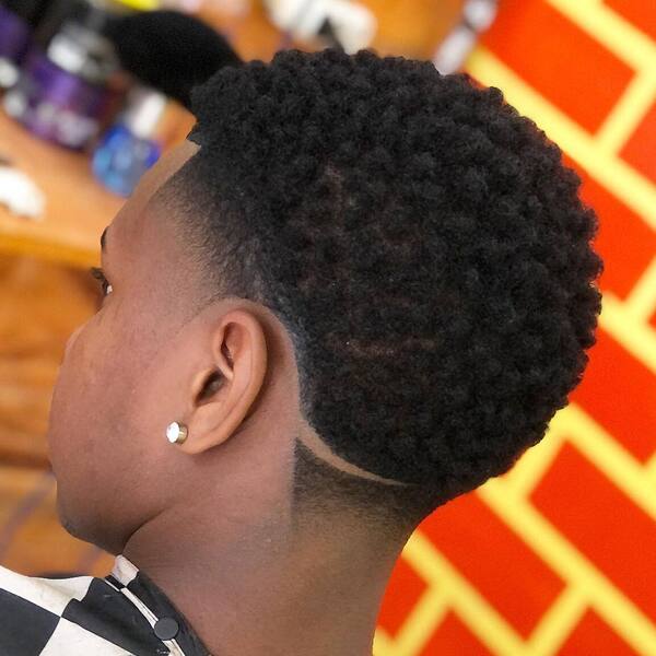 High Taper Fade with Line Afro - a man had his High Taper Fade with Line Afro with earrings