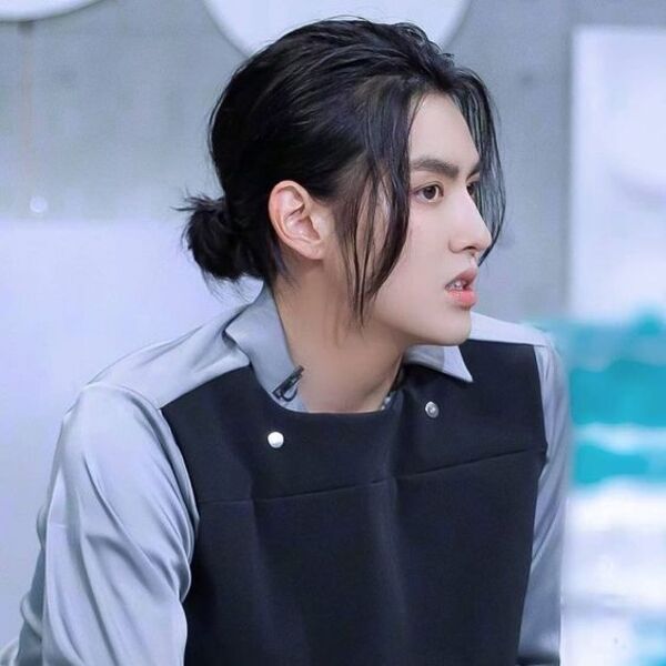 Korean Style Ponytail Hairstyles for Men - a man had his Korean Style Ponytail with shirt
