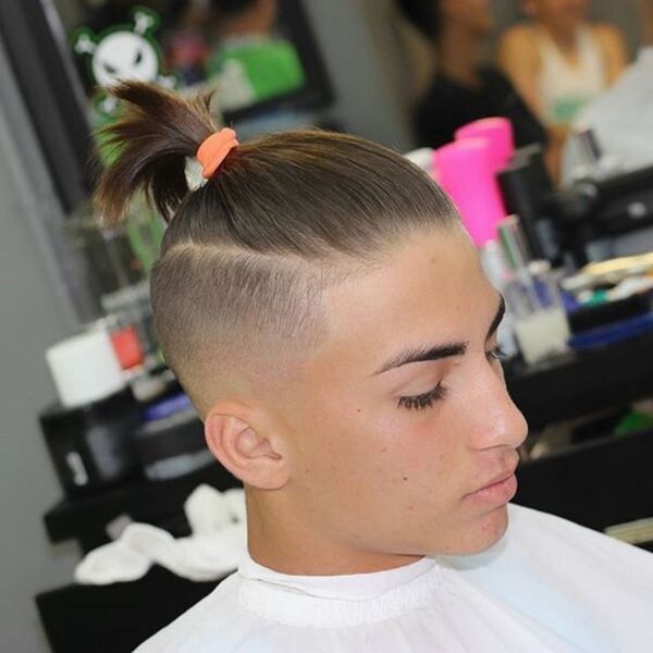 Razored Side Fade Ponytail Hairstyles for Men - a man had his Razored Side Fade Ponytail with shirt