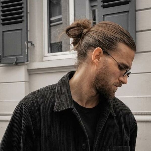 Slicked Back Ponytail Hairstyles for Men - a man had his Slicked Back Ponytail with beard