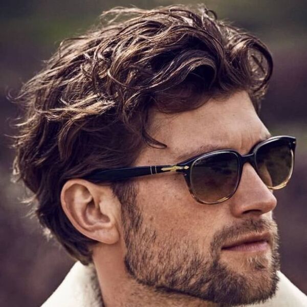 Spritz Out Wavy Celebrity Hairstyles for Men- a man had his Spritz Out Wavy waering shades