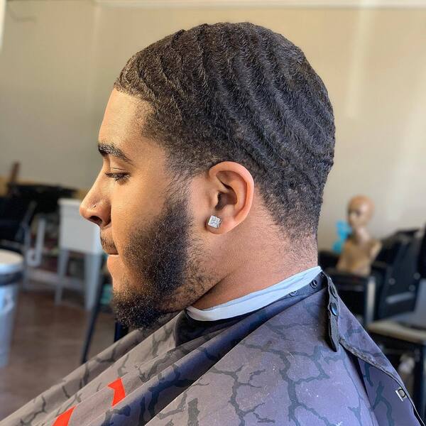 360 Afro Waves with Low Taper and Beard- a man wearing a black barber's cape