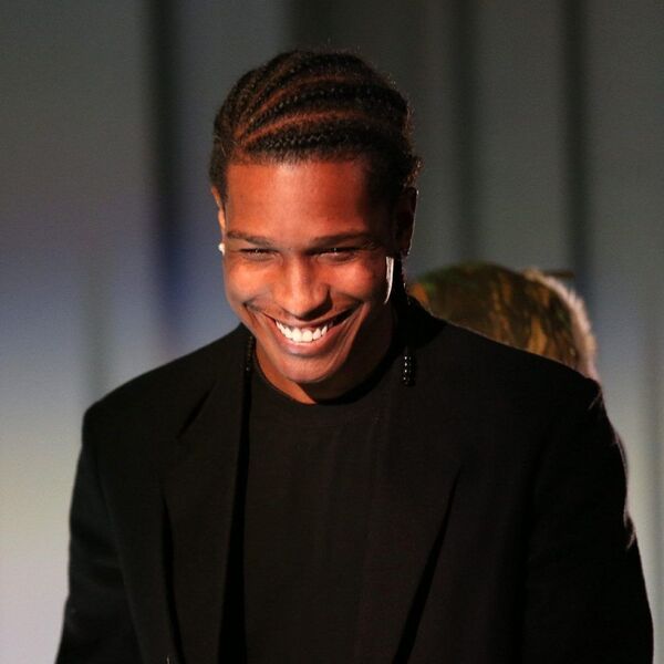 Classic Cornrows- A man wearing a black suit