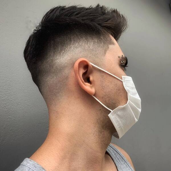 Classic Faux Hawk Fade- a man wearing a white face mask