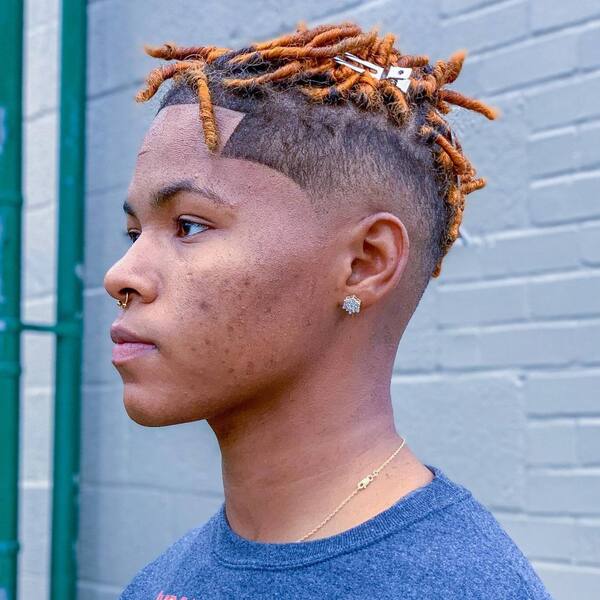 Copper Afro Dreads with Mid Taper Fade- a man wearing a wearing a blue t-shirt