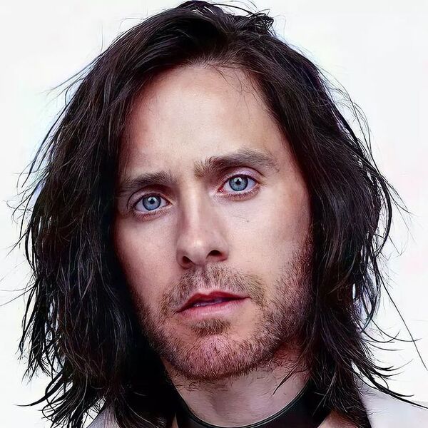 Semi Frizzy Side Part- Jared Leto wearing a white suit with black collar