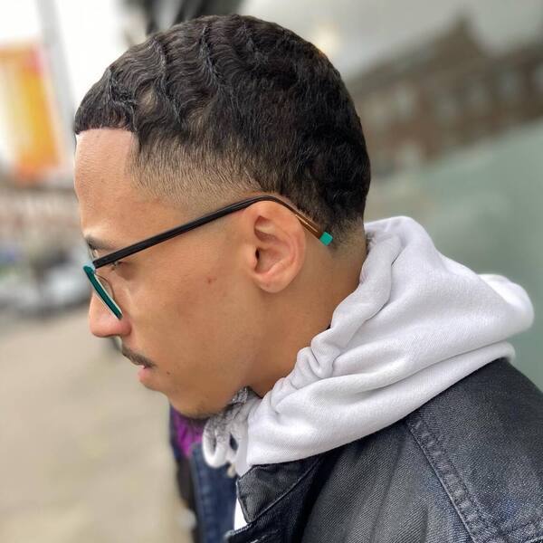 Smooth and Wavy Afro with Taper Fade- man wearing a black hood jacket