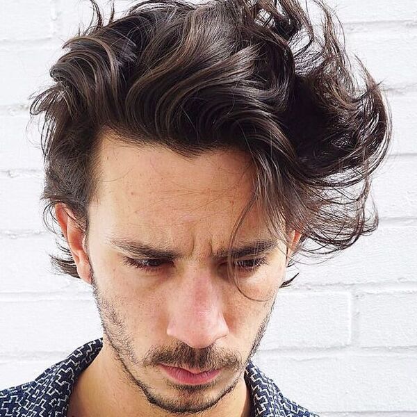 a man wearing printed polo with flow hairstyle