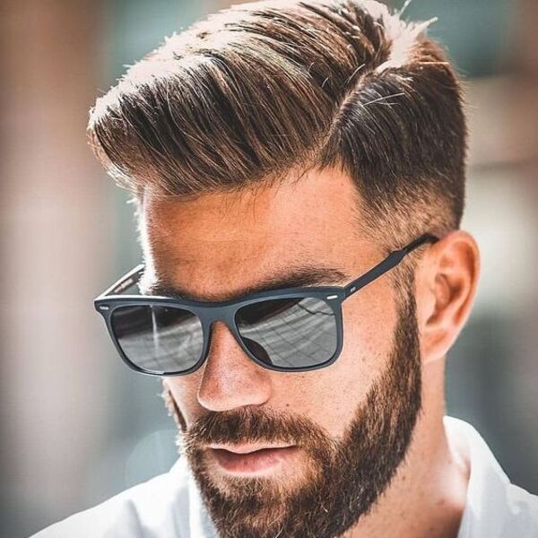 a man wearing sunglasses with mexican haircuts