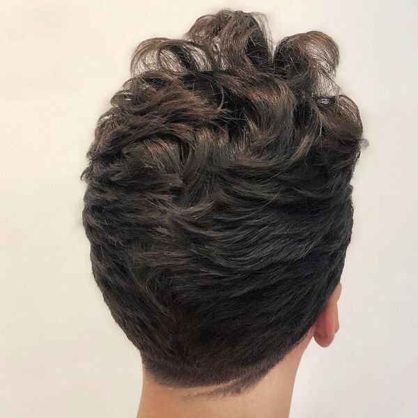 a close up look of man's hairstyle