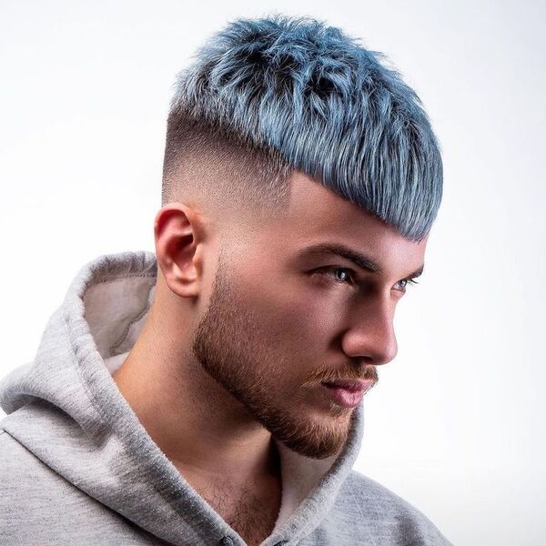 a man wearing gray hoodie jacket with his powder blue hair